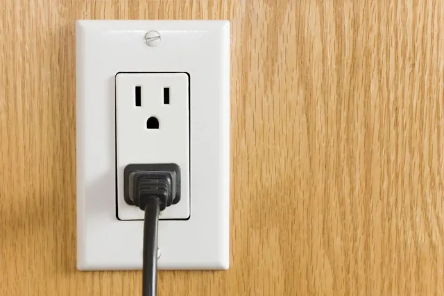 A wall outlet with a plug