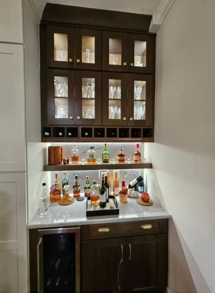 Bar cabinet with lit glass-front uppers and shelf lighting
